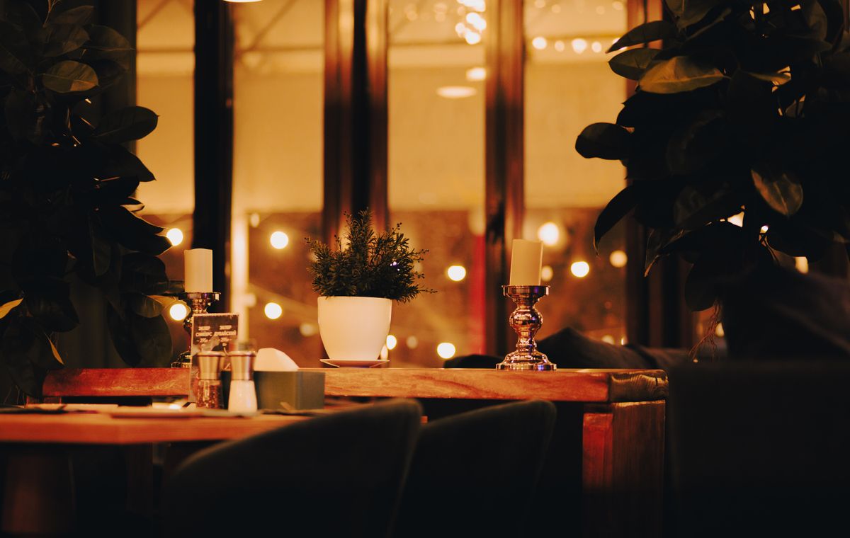 Candlelit table set for an intimate small-plates service.