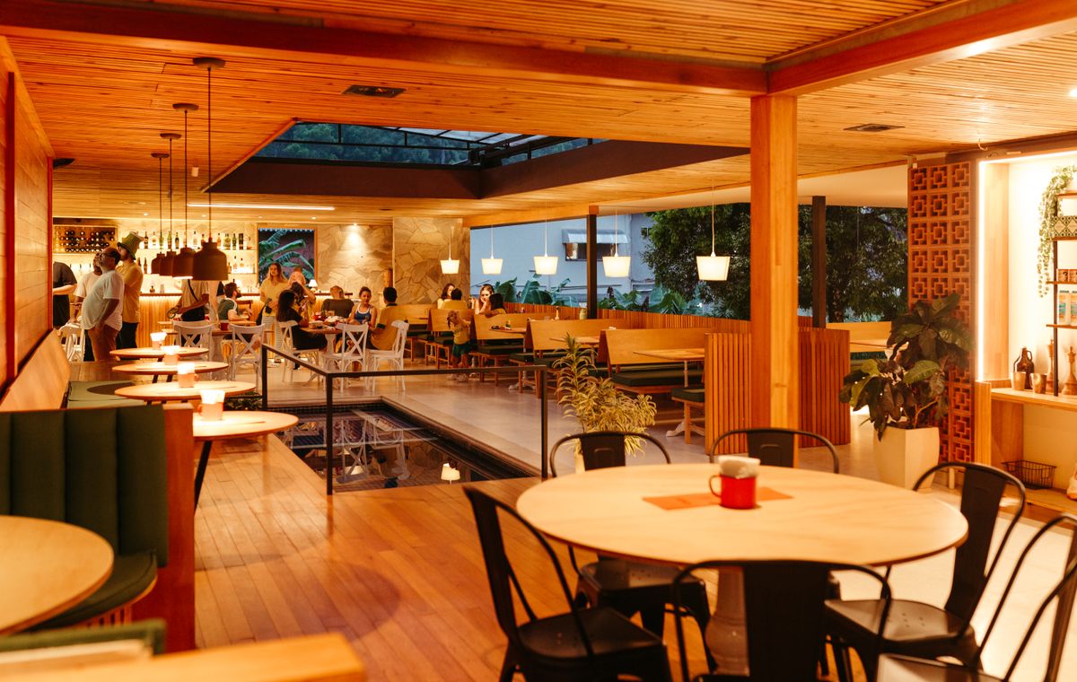 Warm, wood-toned coastal dining room at service.